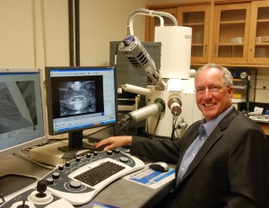 A photo Electron Microscopy Facility Manager Clive Hayzelden sitting at the controls of the Carl Zeiss Ultra55 field emission scanning electron microscope