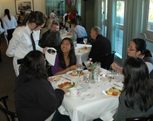 A student serves diners in the Vista Room. 