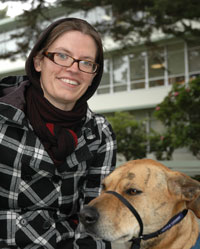 Photograph of biology student Genevieve Walden with her service dog Trigger. 