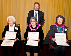 A photo of the three Japanese American honorees with President Corrigan