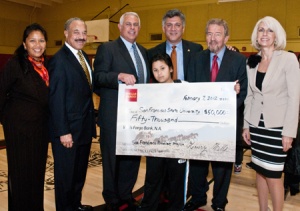 A photo of dignitaries from the San Francisco Mayor's Office, San Francisco Unified School District, Wells Fargo Bank and San Francisco State University, and a Martin Luther King Middle School student, with a check from Wells Fargo to SF Promise.