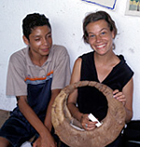 Photo of Caitlin Collentine sitting next to a young El Salvadoran