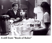 Image: a still from "Book of Rules" featuring a young man talking with a waitress