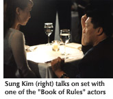 Photo of Sung Kim talking on the set of "Book of Rules" with one of the actors