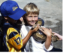 Photo of two boys holding a small boa constrictor