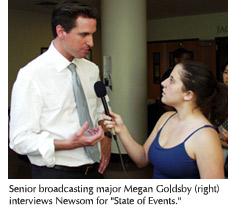 Photo of Gavin Newsom being interviewed by a student reporter