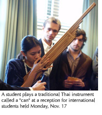 Photo of a student playing a "can," a traditional Thai instrument