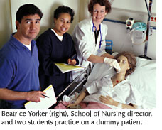Photo of Beatrice Yorker, School of Nursing director, and two students practicing on a dummy patient
