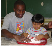 Photo of AmeriCorps volunteer working with a preschool student through Jumpstart