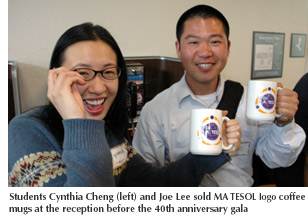Photo of students Cynthia Chen and Joe Lee who sold MA TESOL logo coffee mugs at the 40th anniversary gala