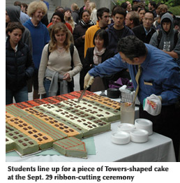 Photo of students lining up for a piece of a cake designed to look like the Towers at Centennial Square
