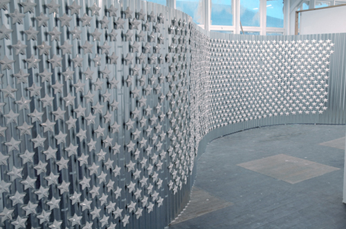 Photo of Hovey's "Diamonds in the Sky" a corrugated tin wall of 1,262 magnetized porcelain stars