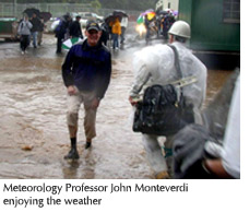 Photo of Meteorology Professor John Monteverdi walking across flooded ground near 19th Avenue