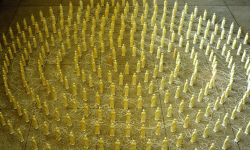 Photo of Mario Laplante's Iluminee, an art installation featuring 390 ceramic priests dipped in beeswax and arranged in circles