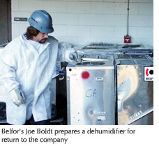 Photo of Belfor employee Joe Boldt preparing a dehumidifier for return to the company