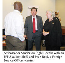 Photo of Ambassador Sanderson speaking with an SFSU student  and Evan Reid, a Foreign Service Officer