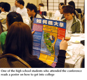 Photo of one of the high school students who attended the conference reading a poster on how to get into college
