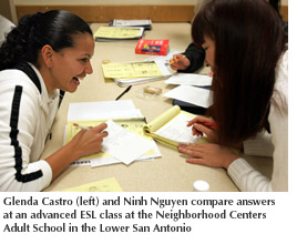 Photo of Glenda Castro and Ninh Nguyen comparing answers at an advance ESL class at the Neighborhoo Centers Adult School in the Lower San Antonio