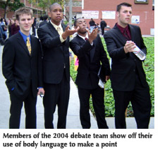 Photo of four members of the 2004 debate team showing off their use of body language to make a point