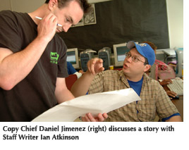 Photo of Copy Chief Daniel Jimenez (right) discussing a story with Staff Writer Ian Atkinson