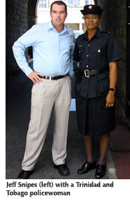 Photo of Jeff Snipes standing next to a Trinidad and Tobago policewoman