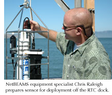 Photo of NetBEAMS equipment specialist Chris Raleigh preparing a sensor for deployment