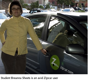 Photo of student Breanna Sheets, an avid Zipcar user, next to one of the cars available on campus