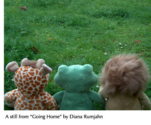 A still from Diana Rumjahn's film "Going Home" showing three stuffed animals looking across an expanse of grass