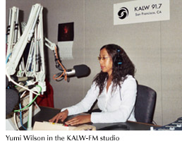 Photo of Yumi Wilson at work in the KALW-FM studio