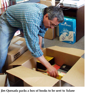 Photo of Jim Quesada packing a box of books to be sent to Tulane University