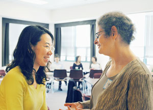 Photograph of student HyunJin Cho (left) talking with Professor Gail Weinstein
