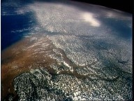 A NASA Space Shuttle photograph shows a nutrient-rich, brown plume from the mouth of the Amazon River spreading out over the tropical Atlantic Ocean.