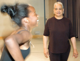 A photo of Professor of Dance Albirda Rose instructing a student in the dance studio.
