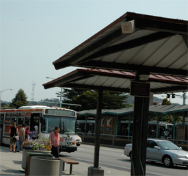 A photo of passengers boarding a bus at 19th and Holloway avenues at San Francisco State with the new Sound Web mounted on the roof of the bus shelter.