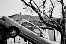 An abandoned car sits in a near vertical position during the aftermath of Hurricane Katrina.