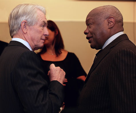 A photograph of Charles Schwab and Willie Brown talking.