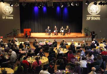 Photo of Alumni Day attendees seated at lunch, listening to an Oscar-winning panel.