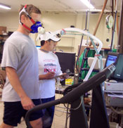 Photo of a participant taking the VO2max test, whcih measures aerobic capacity. Participant is walking on a treadmill.