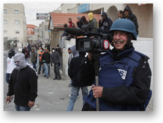 A photo of SF State Professor Ken Kobré covering a clash between Palestinian youth and Israeli soldiers outside Jerusalem for his film, 