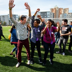 Students engaged in an activity outdoors on the West Campus Green