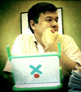 A photo of Sameer Verma with an XO laptop.