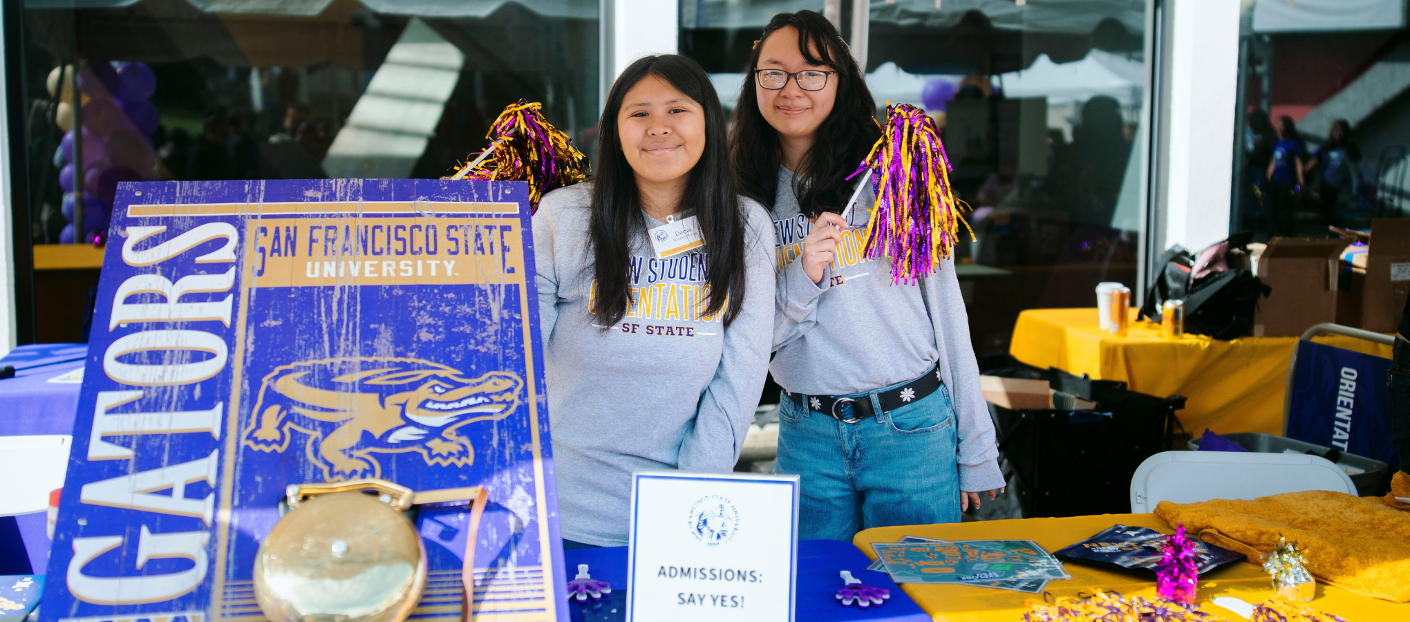 SFSU's admissions bell with two students cheering