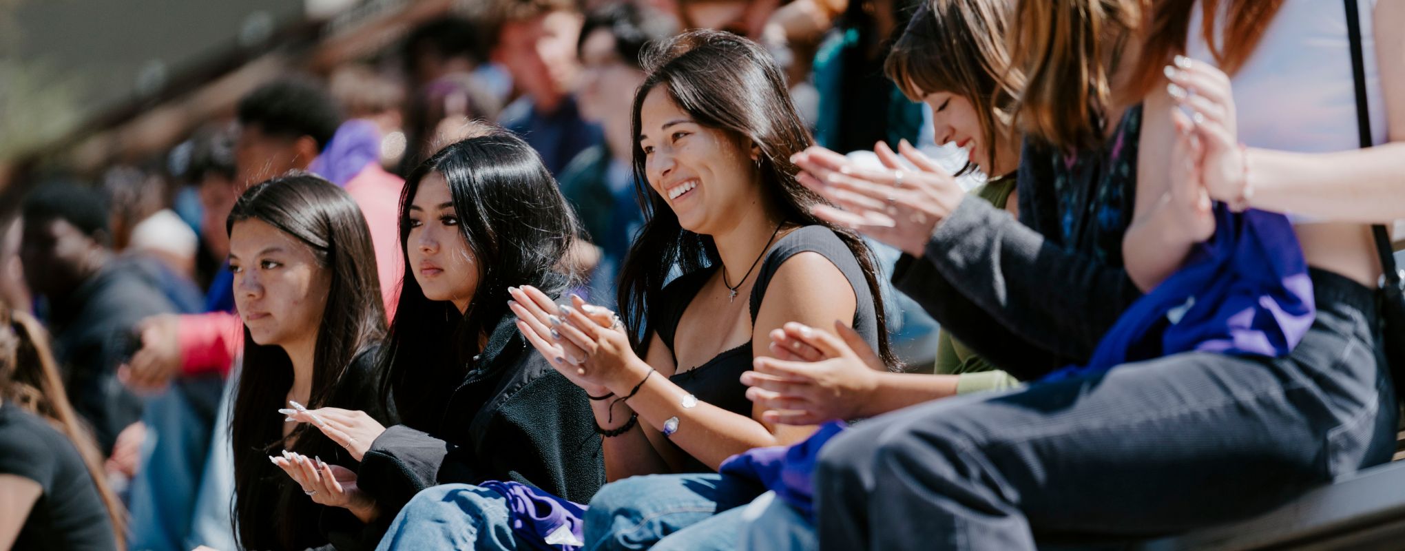 Students clap for at the end of Freshman orientation pinning ceremony