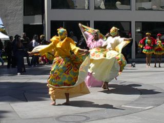 Three African dancers in the middle of their dance performance