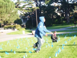 Two students planting blue flags in motion