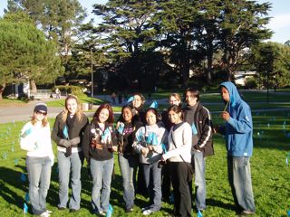 Group photo of the 10 peer educators who helped place the flags in the lawn