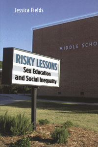 A photograph of the book jacket for "Risky Lessons" by Jessica Fields, which features a sign in front of a middle school building.