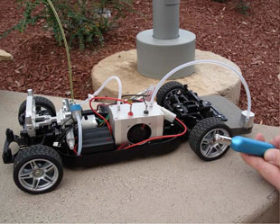 Photo of the team's remote controlled fuel cell model car with mechanisms exposed.
