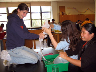 A scientist with high school students.