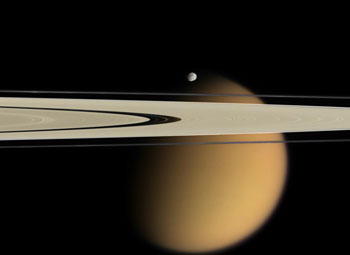 A color satellite image of Saturn and its rings, with Titan visible.